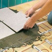 How to make an electric heated floor under tiles: film and cable options