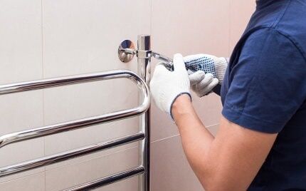 What is the best way to replace a heated towel rail in a bathroom?