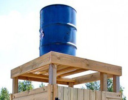 Summer shower barrel on a wooden support