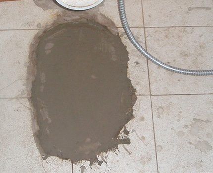 The floor where the old toilet used to be