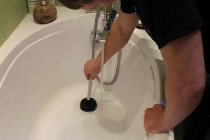 Clearing a clog with a rubber plunger