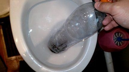 Cleaning the toilet with a bottle