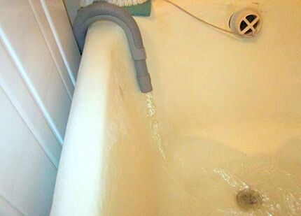 Release the drain hose into the bathtub