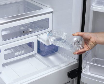 Pouring water into the ice maker