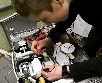 The technician checks the dishwasher