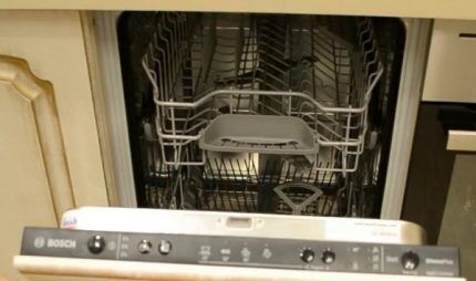2nd generation BOSCH dishwasher with closed information display, built into the kitchen interior