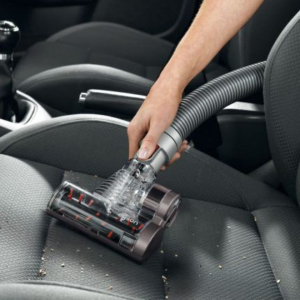 Cleaning the car interior with a cordless vacuum cleaner
