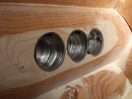 Metal socket boxes in a wooden wall