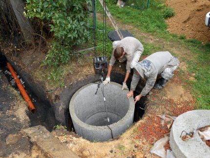 Craftsmen installing a well