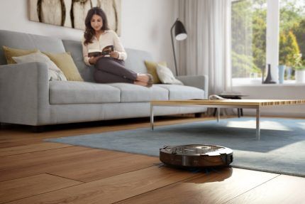 Robot vacuum cleaner in the process of cleaning laminate flooring