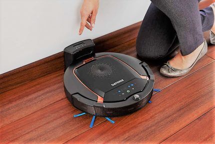 The robot vacuum cleaner is charging on the base
