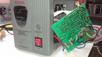 A mechanic disassembles a voltage stabilizer