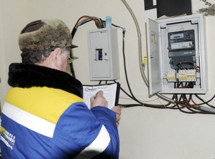 A specialist takes meter readings