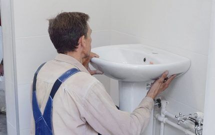 Handyman installs a small sink