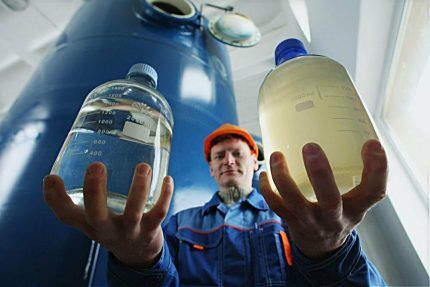 A man holds bottles with reagents in his hands