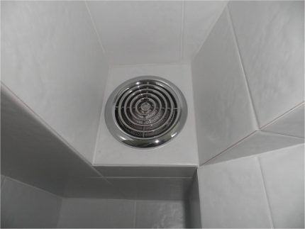 Exhaust fan on tiled wall