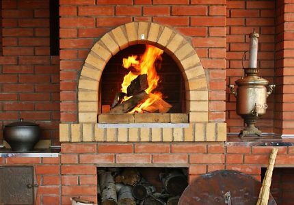 Crucible of a Russian stove with burning logs