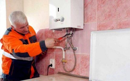 A technician changes a gas water heater