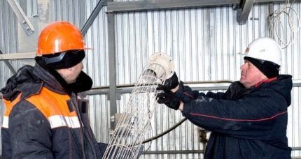 Workers replace a bag filter