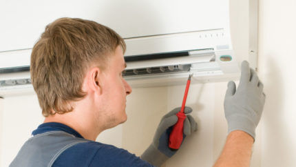 The technician disassembles the air conditioner