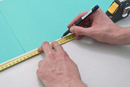 Marking on a sheet using a tape measure