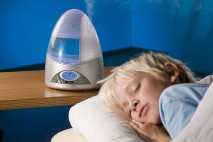 Baby sleeps near a humidifier