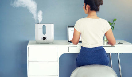 Woman at table with humidifier