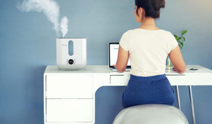 Femme à table avec humidificateur