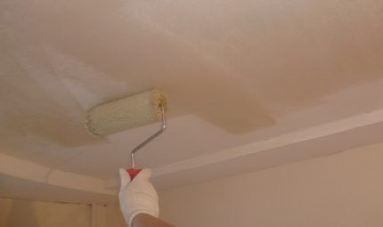 Applying primer to the ceiling