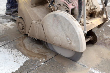 Concrete floor screed is cut with a joint saw