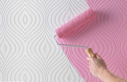 Non-woven wallpaper is painted pink with a roller