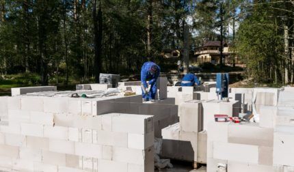Builders lay aerated blocks with glue
