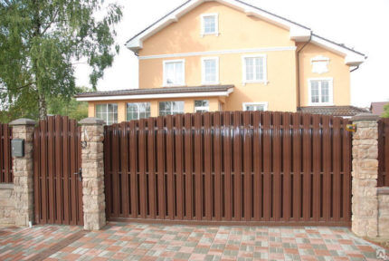 Gate made of brown euro picket fence