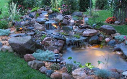Decorated pond with cascading waterfall and lighting
