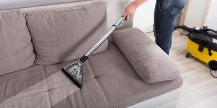 Cleaning the sofa with a washing vacuum cleaner