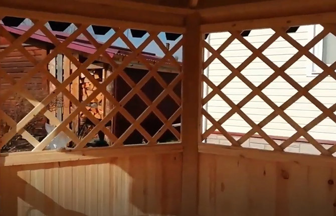 The windows of the hexagonal gazebo are completely covered with battens